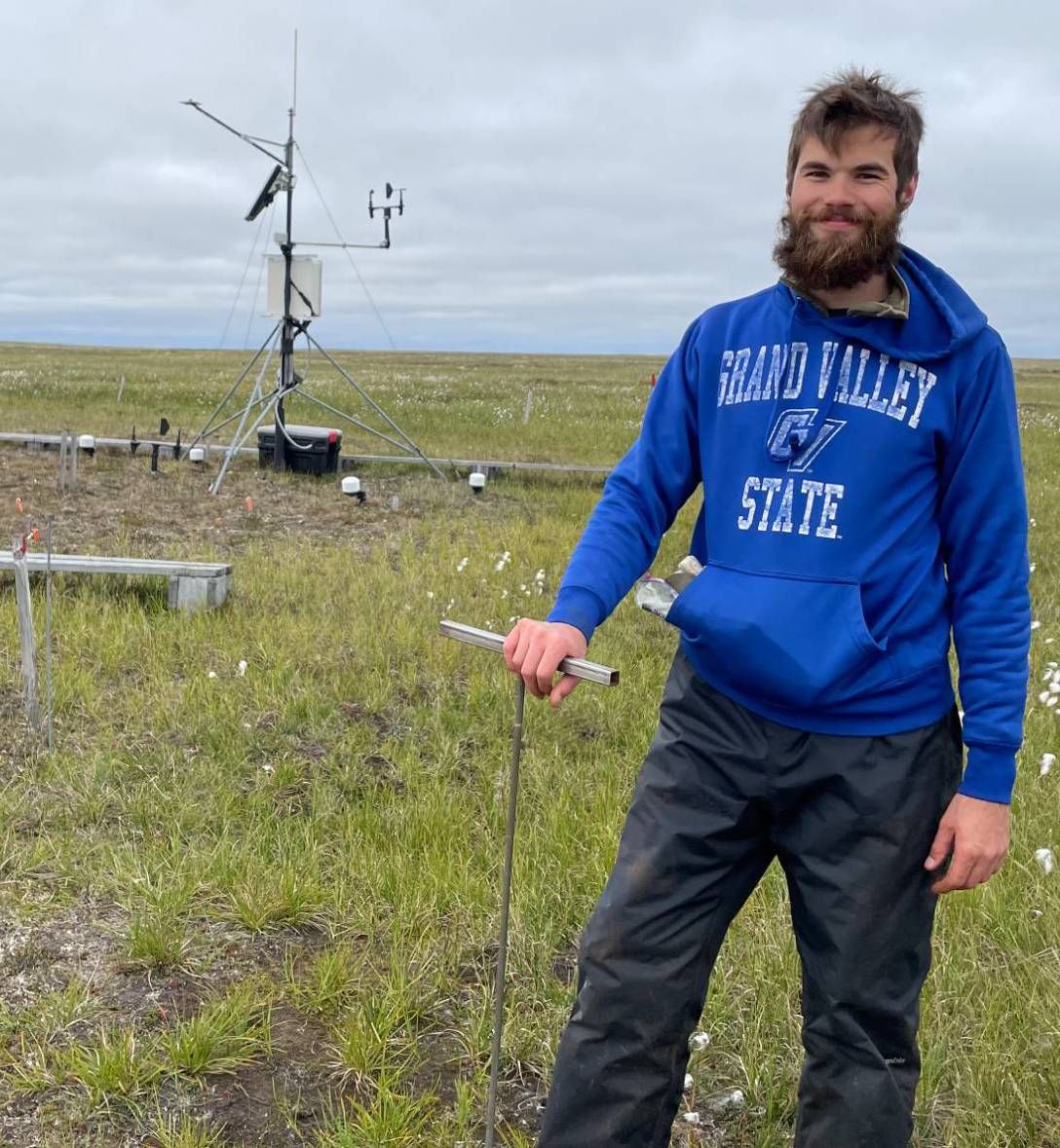 Researcher holding a thaw depth probe